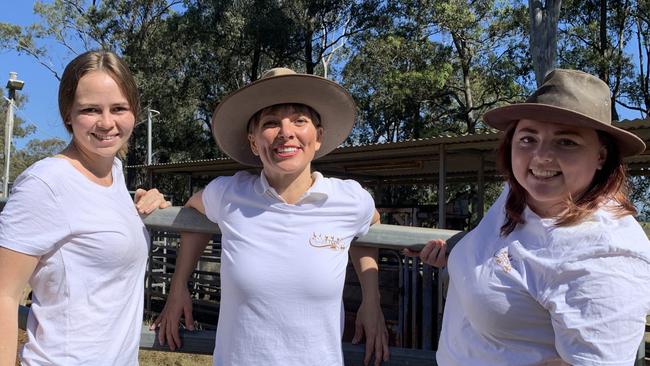 (L-R) Farm foster mum Kirra Smith, Til The Cows Come Home farm animal charity founder and CEO Donna Wild, and rescue team coordinator Phoebe Wisken with the 27 head of cattle bound for their forever home.