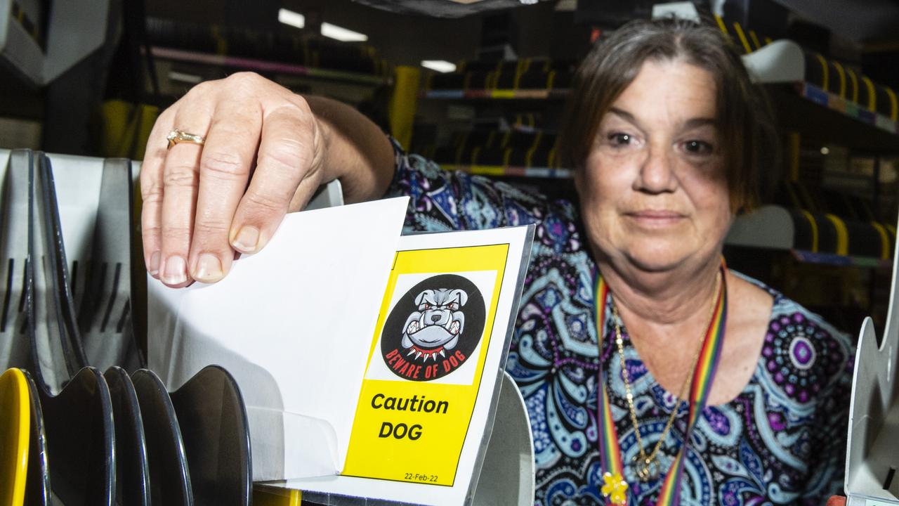 Australia Post delivery manager Susan Mason places a hazard card used to report problematic addresses between posties. Picture: Kevin Farmer