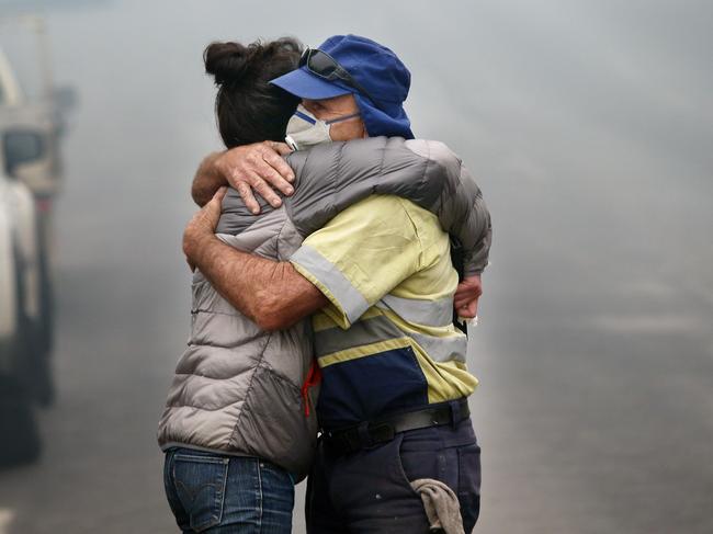 The morning after a devastating blaze destroyed homes and businesses in the small town of Cobargo. Shona Taranto is comforted by Tim O'Mearo. Picture: Gary Ramage