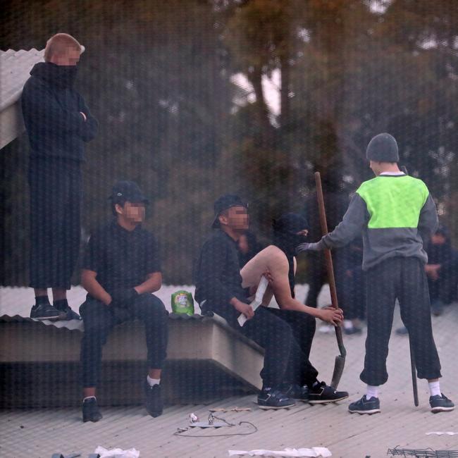 Inmates from the Frank Baxter Juvenile corrections centre Kariong taunt police from the roofs of various buildings. Some are armed with poles tennis rackets ect. Picture: John Grainger