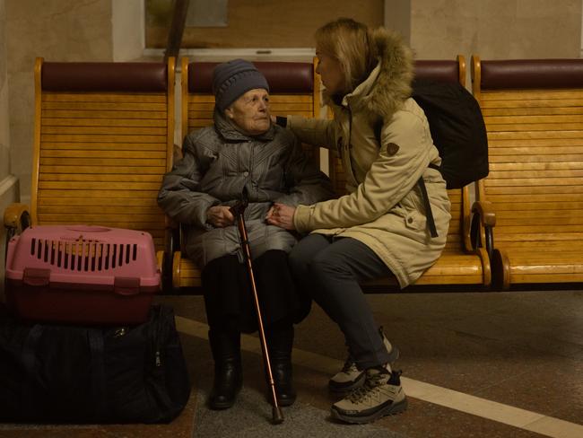 An elderly woman is comforted by a family member while waiting to board an evacuation train in Kherson, Ukraine. Picture: Chris McGrath/Getty Images