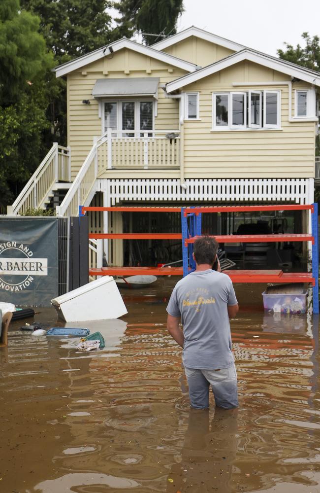 A man watches his home in floodwaters at Torwood Street, Auchenflower (Photo: Peter Wallis/Getty Images)