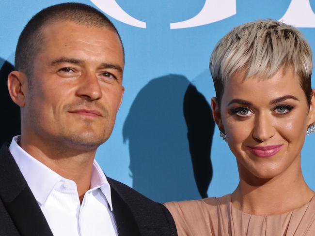 (FILES) In this file photo British actor Orlando Bloom (L) and US singer Katy Perry pose upon their arrival at the 2nd Monte-Carlo Gala for the Global Ocean 2018 held in Monaco on September 26, 2018. - It was a twofer for fans of Katy Perry: the pop star confirmed that she and partner Orlando Bloom are expecting a baby, revealing the surprise as she dropped her latest music video.The new single "Never Worn White" sees Perry, 35, cradling a baby bump in the final seconds of the video, released late March 4, 2020. Shortly before it dropped Perry had published an extract of the clip which had fueled speculation on social media that she might be expecting."Let's just say it's gonna be a jam packed summer..." Perry wrote afterwards on her various social media channels."So glad I don't have to suck it in anymore... or carry a big purse," she told her 108 million Twitter followers. (Photo by Valery HACHE / AFP)