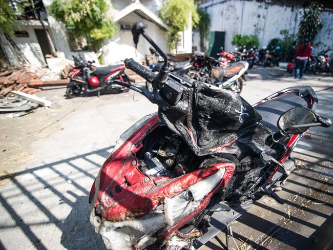 A damaged motorcycle is seen outside the Gereja Pantekosta Pusat Surabaya (Surabaya Centre Pentecostal Church) in Surabaya. Picture: AFP