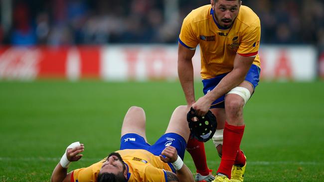 Dejected Romanian rugby players Florin Vlaicu and Valentin Poparlan.