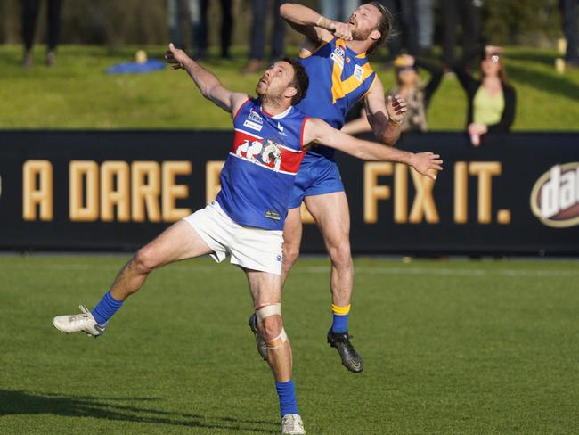 SFL: Cranbourne’s Brandon Osborne jumps over his opponent. Picture: Valeriu Campan