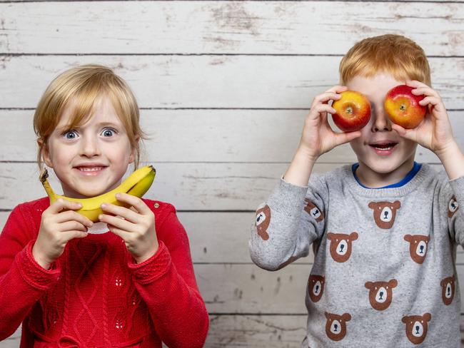 Twins Macy and Arlo, 5, playing with brightly coloured fruit and veg - the researchers ask kids to make a picture or face on a paper plate with the foods.Kids who did this were more likely to want to eat it than others who did a game with non-food items.Esp good for kids who are picky, sensitive and anxious as it allows them to slowly get used to textures of food. Picture: Tim Carrafa