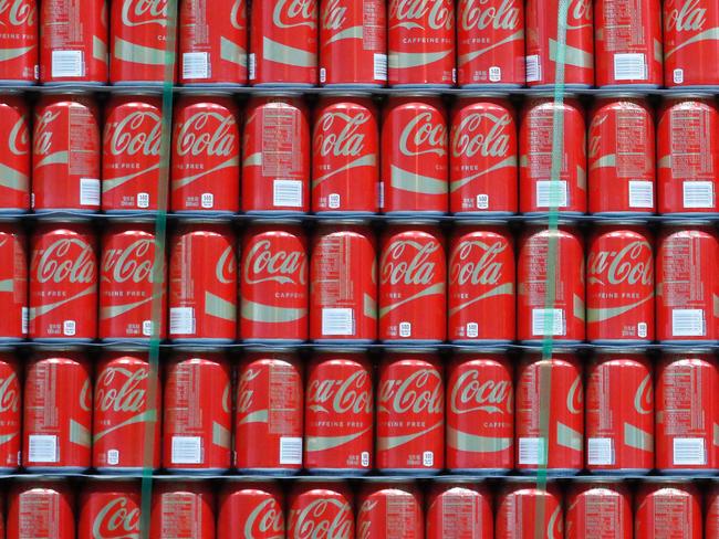 (FILES) This file photo taken on February 9, 2017 shows pallets of Coke-Cola cans waiting to be shipped out at a Coco-Cola bottling plant in Salt Lake City, Utah. Coca-Cola reported lower earnings on April 25, 2017 on restructuring costs and flat volumes as it touts new low-sugar beverages in response to flagging demand for soda.Net income in the first quarter was $1.2 billion, down 20.3 percent from the year-ago period. / AFP PHOTO / GETTY IMAGES NORTH AMERICA / GEORGE FREY