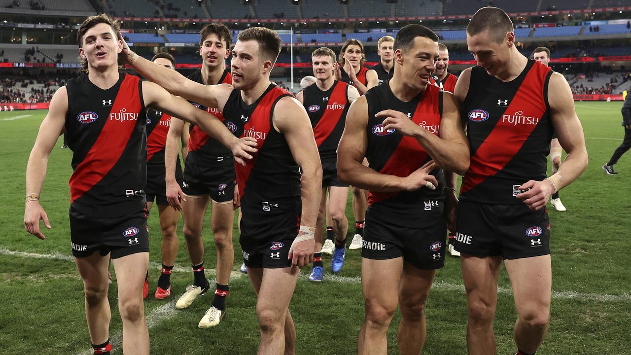 MELBOURNE, AUSTRALIA - AUGUST 04: Bombers players leave the ground during the round 21 AFL match between Essendon Bombers and Fremantle Dockers at Melbourne Cricket Ground, on August 04, 2024, in Melbourne, Australia. (Photo by Martin Keep/AFL Photos/via Getty Images)