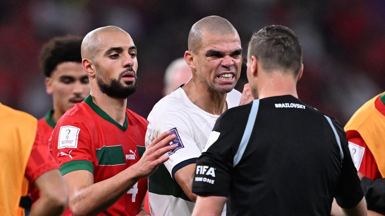 Portugal's defender #03 Pepe (C) argues with Argentinian referee Facundo Tello next to Morocco's midfielder #04 Sofyan Amrabat (L) during the Qatar 2022 World Cup quarter-final football match between Morocco and Portugal at the Al-Thumama Stadium in Doha on December 10, 2022. (Photo by Kirill KUDRYAVTSEV / AFP)