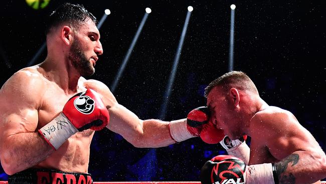 Goulamirian (L) lands a stiff jab on Mark Flanagan. Picture: AFP