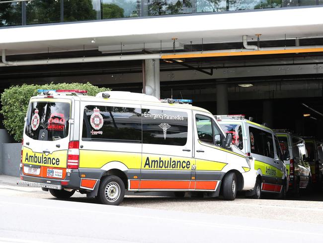 Guests in quarantine at the Hotel Grand Chancellor are taken by ambulance to other hotels. Picture: Tara Croser