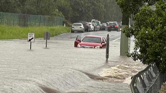 Car abandoned in floodwater at Siganto Drive in Helensvale