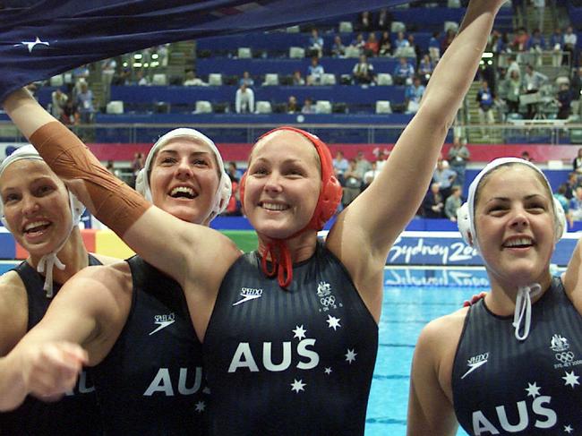 Liz Weekes (centre) celebrates with her team after winning gold. Picture: Gregg Porteous