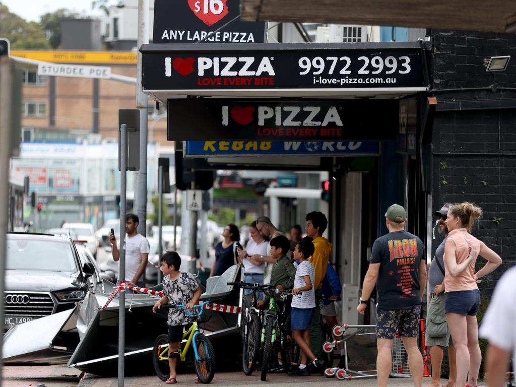 Parts of the air con unit pictured on the road after it flew off the building on the other side of the road. An aircondtitioning unit has blowed off an apartment building on Pittwater road in Narrabeen after a storm ripped through the Northern Beaches. Picture: Damian Shaw