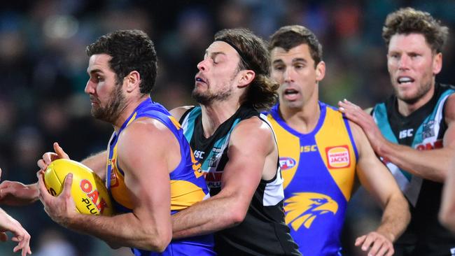 Jarrod Lienert of the Power tackles Jack Darling, who had a dirty night at Adelaide Oval. Picture: AAP Image/David Mariuz