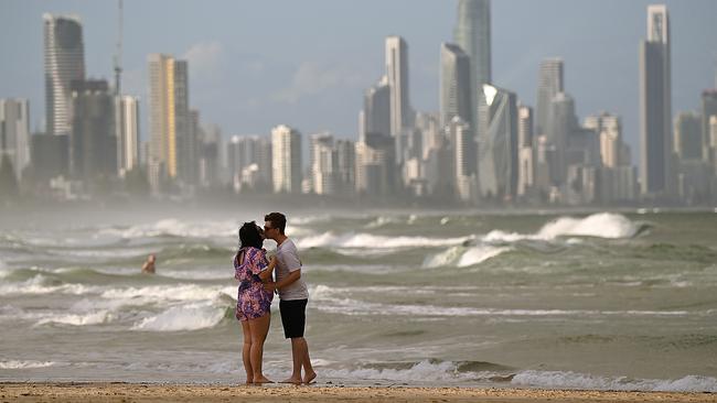 A couple on a near-empty beach at Burleigh Heads on the Gold Coast on Thursday. Picture: Lyndon Mechielsen