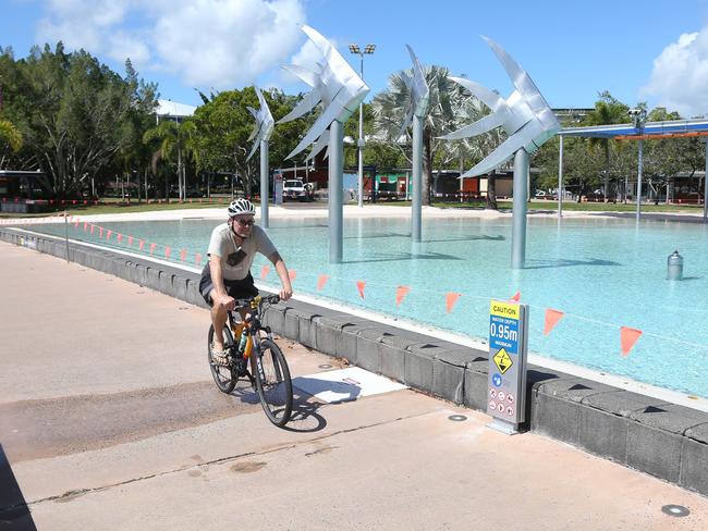 The Cairns council area and the indigenous community of Yarrabah have been cleared by the Queensland Government to come out of their 3 day lockdown, after no new positive cases of the Covid-19 coronavirus were detected in the communities. A man rides his bicycle along the closed swimming lagoon on the Esplanade. Picture: Brendan Radke