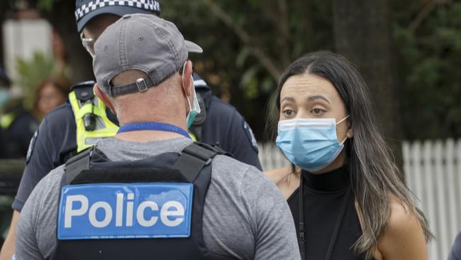 Sunday Herald Sun reporter Olivia Jenkins speaks to police at Melbourne’s anti-vaxxer rally. Picture: NCA NewsWire / David Geraghty