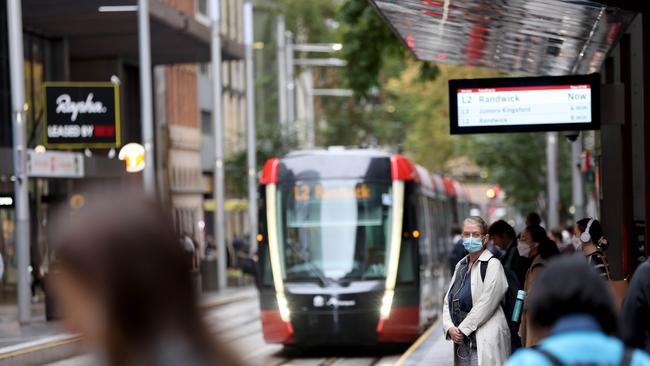 People wait for the light rail on George Street in the Sydney CBD. Picture: NCA NewsWire / Damian Shaw