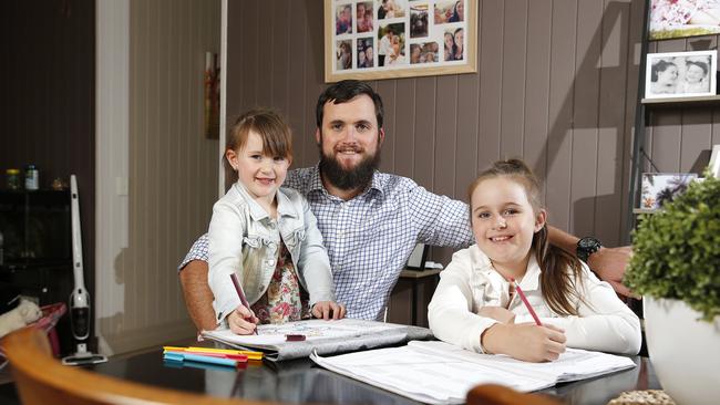 Dad Tim Powers pictured spending time with his kids Mia, 8, and Sophie, 4, at their home in Ipswich. Picture: AAP Image/Josh Woning