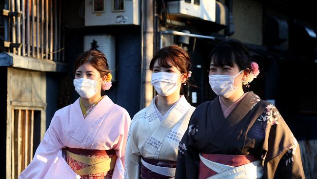 Women dressed in Kimono and face masks in Kyoto, Japan. The tourism industry in Japan as seen a major decline and not all are unhappy about it.