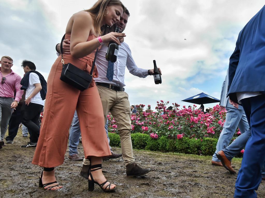 Punters in the mud at the 2018 Melbourne Cup Flemington. Picture: Jason Edwards