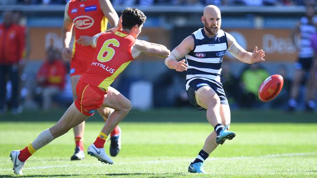 Gary Ablett gets a kick away under pressure from Alex Sexton.