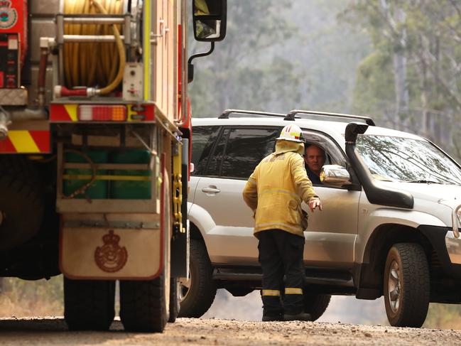 Firefighters battle bushfires in Busbys Flat, northern NSW, Wednesday, October 9, 2019. (AAP Image/Jason O'Brien)