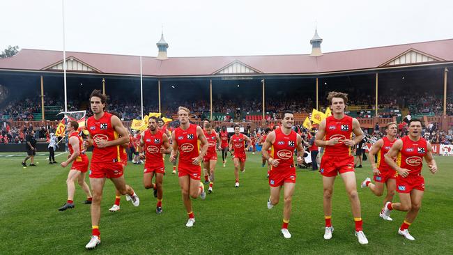 The Suns run onto Norwood Oval. Photo by Michael Willson/AFL Photos via Getty Images.