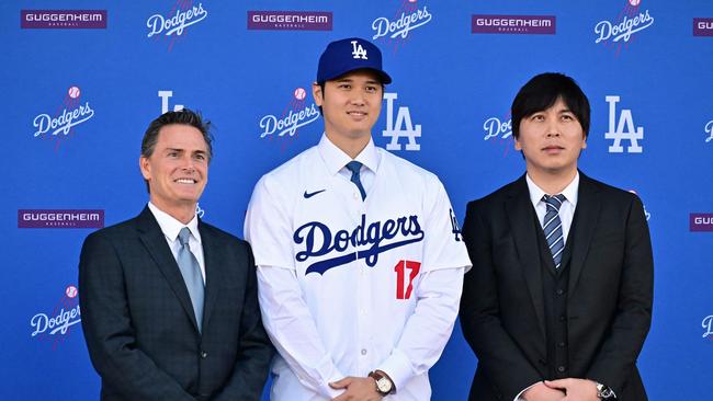 Shohei Ohtani (centre) poses with his agent Nez Balelo (left) and his former Japanese interpreter Ippei Mizuhara after signing a 10-year deal with the Dodgers. (Photo by Frederic J. Brown / AFP)