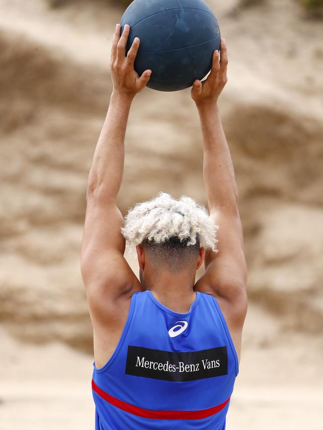 Jason Johannisen lifts a medicine ball. Picture: Michael Klein