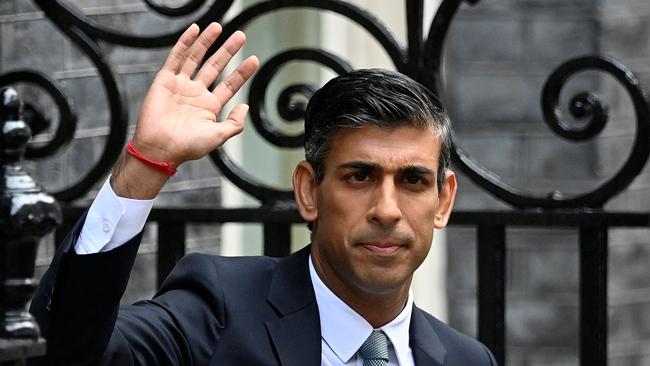 Britain's newly appointed Prime Minister Rishi Sunak waves as he poses outside the door to 10 Downing Street in central London on Tuesday. Picture: AFP