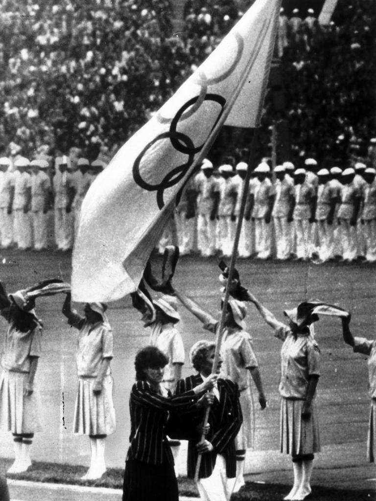 Australia’s Denise Boyd and Max Metzker lead the Australian team into the Moscow Olympics under the Olympic flag. Picture: File