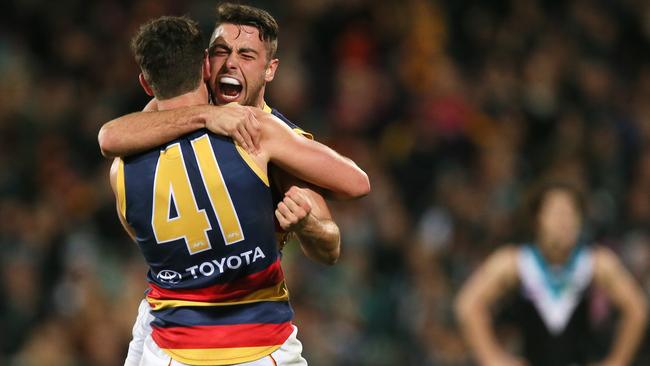 Mitch McGovern and Jake Lever celebrate a goal against Port Adelaide.