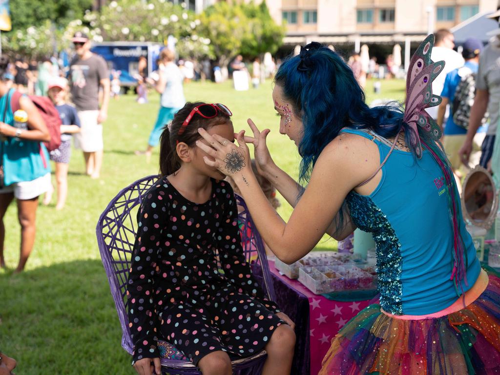 A young girl gets a paint makeover. Picture: Pema Tamang Pakhrin