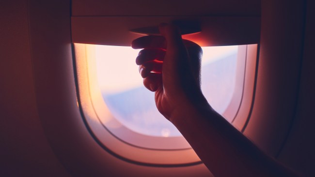 Traveling by plane. Manually raising and lowering window blinds during the flight.