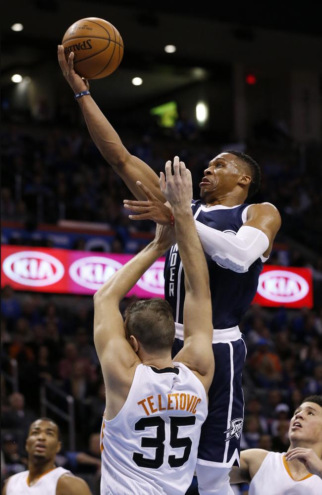 Oklahoma City Thunder guard Russell Westbrook shoots in front of Phoenix Suns' Mirza Teletovic.