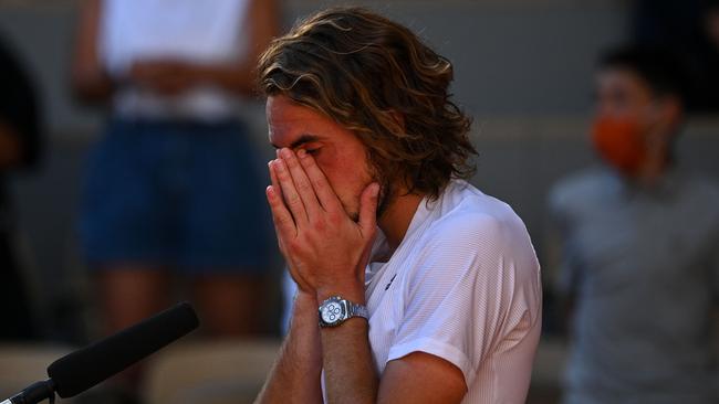 Stefanos Tsitsipas cries after winning against Alexander Zverev. (Photo by Anne-Christine POUJOULAT / AFP)