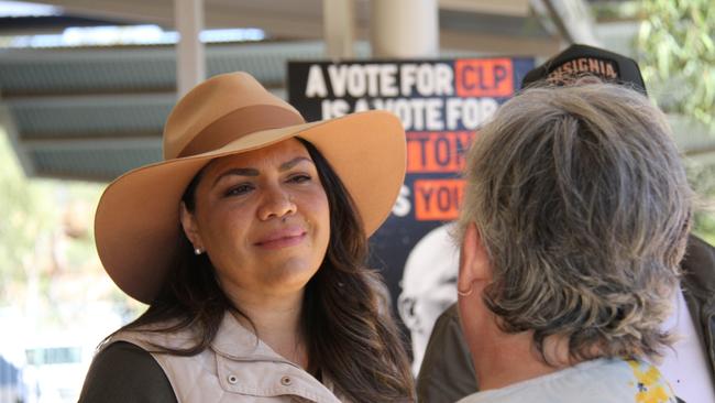 NT Senator Jacinta Price speaks to an Alice Springs resident after casting her vote alongside her husband Colin Lillie in the 2025 federal election at Braitling Primary School, Alice Springs, May 3, 2025. Picture: Gera Kazakov