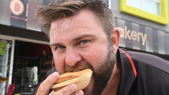 Shaun Pyne tucks into a hearty pie at Marcoola Bakery.