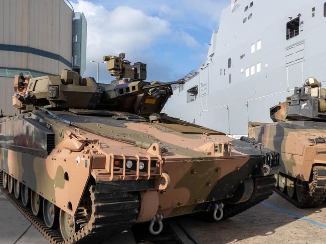 Australian Army Infantry Fighting Vehicles, Hanwha Defense Australia Redback(left) and the Rheinmetall Defence Australia KF-41 Lynx, stand ready to board HMAS Adelaide at HMAS Kuttabul, NSW. *** Local Caption *** The choice between Hanwha's Redback and Rheinmetall's KF41 Lynx represents the biggest acquistion in Army's history, costed at up to $27.1 billion.  Sea transportability trials come at the end of two years of extensive field user testing of the two vehicles, with a recommendation to go to government for a decision next year.