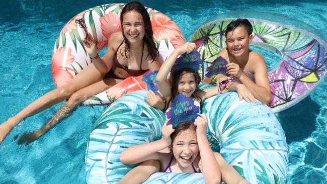 Zara Papst, 14, and Jed Papst, 12, with cousins Maggie Prior, 10, and Ava Prior, 8, in the pool for the count down to 2022. Picture: Emma Brasier