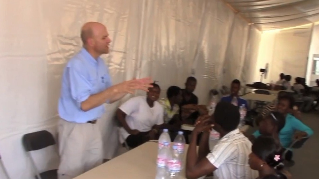 Dr John Gerrard, seen here teaching workers at the ebola treatment centre in Sierra Leone, lobbied for the creation of the Gold Coast University Hospital.