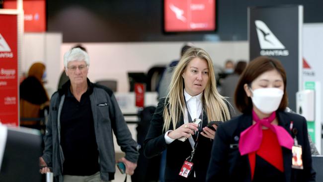 Qantas executive Olivia Wirth, pictured, helping people check in at T3 Qantas Domestic departures terminal at Sydney Airport ahead of the winter school holidays. Picture: NCA NewsWire/Damian Shaw