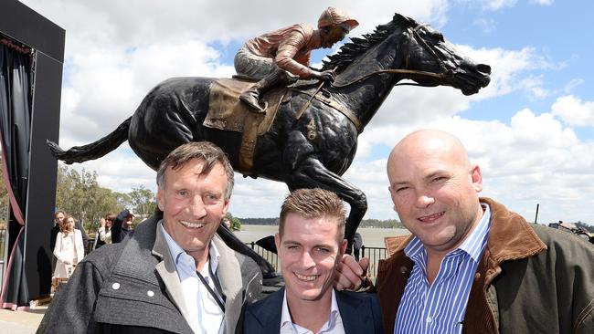 Luke Nolen (middle), Peter Moody (right) and breeder Rick Jameison in front of a bronze statue of Black Caviar.