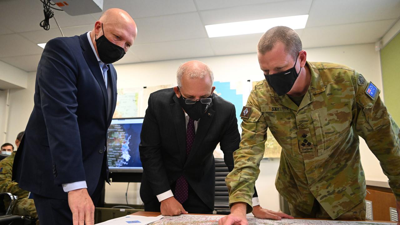 Scott Morrison and defence Minister Peter Dutton receive a briefing regarding the Army’s flood assistance from Brigadier Michael Say. Picture: NCA NewsWire / Dan Peled