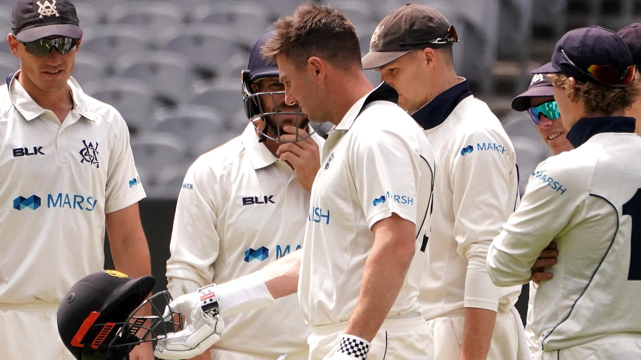 Shaun Marsh inspects his helmet after being hit multiple times.