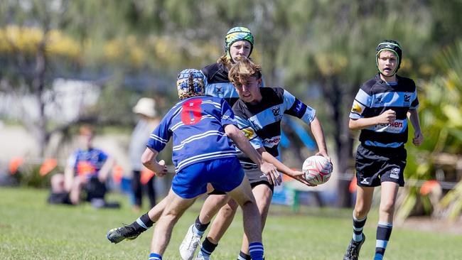 Day One of King of the Country rugby tournament at James Overell Park, Southport. Maroochydore Swans U14s (black/ blue stripes) v USQ Saints U14s (blue white small stripes). Picture: Jerad Williams