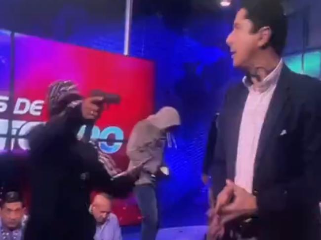 A group of armed men broke into a live television studio in Ecuador and threatened staff, footage shows. Picture: TC